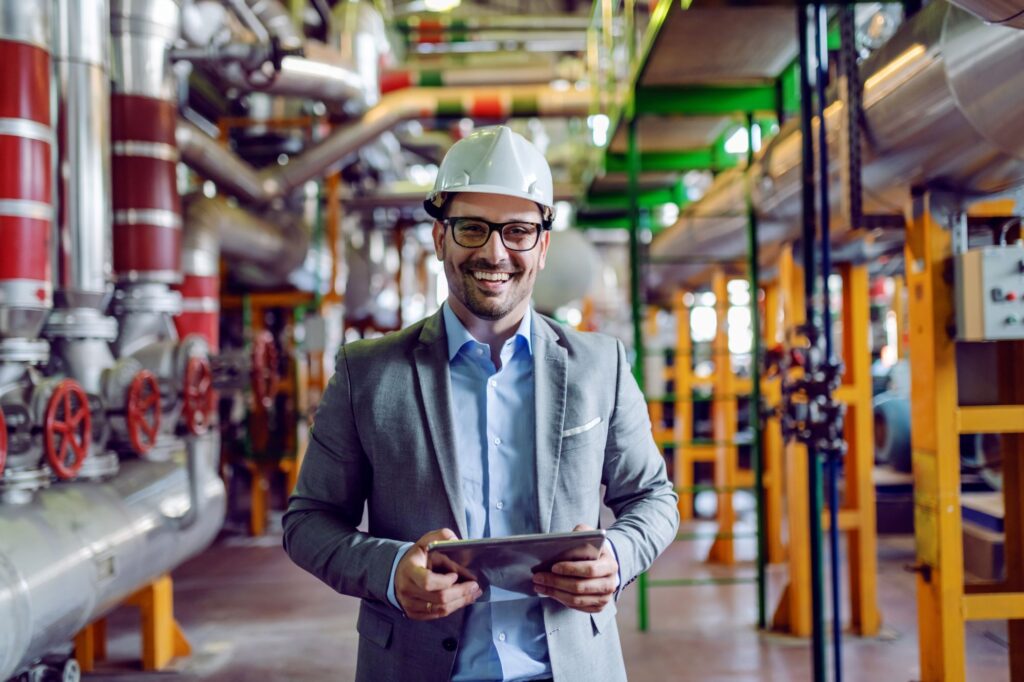 A chemical engineer holding an electronic tablet at an energy plant