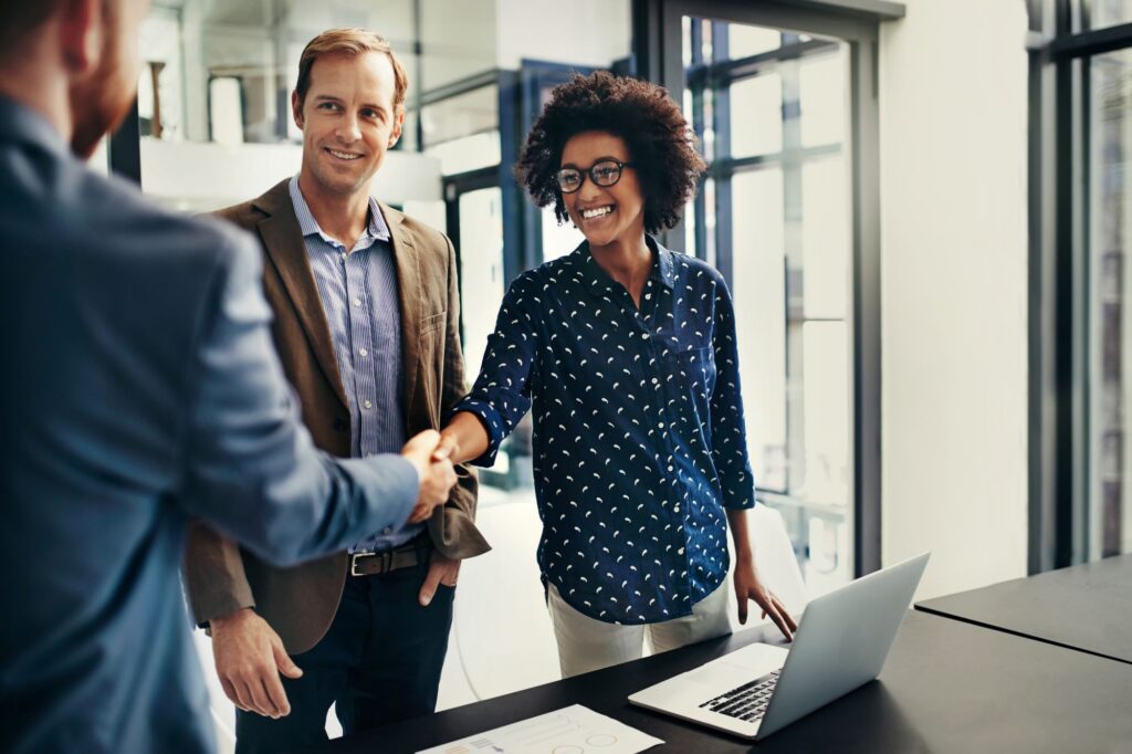 business professionals shaking hands during a meeting at work